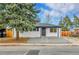 Charming home featuring a well-maintained front yard and freshly painted exterior at 12801 Randolph Pl, Denver, CO 80239