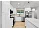 Modern kitchen with stainless steel appliances, white cabinetry and a beautiful backsplash at 12801 Randolph Pl, Denver, CO 80239