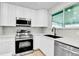 The kitchen has stainless appliances, a modern faucet and beautiful white countertops at 12801 Randolph Pl, Denver, CO 80239