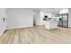 Open-concept with modern finishes featuring wood flooring and a pristine white kitchen at 12801 Randolph Pl, Denver, CO 80239