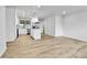 Open floor plan showcasing the modern kitchen and expansive wood laminate flooring at 12801 Randolph Pl, Denver, CO 80239