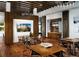 Elegant dining area featuring a wooden table and chairs under a stylish chandelier and wood-beamed ceiling at 2078 S Teller Ct, Lakewood, CO 80227