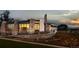 Elegant exterior with stone details, large windows, and lush landscaping at 2078 S Teller Ct, Lakewood, CO 80227