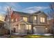 Charming two-story home with a covered front porch, swing, and a well-manicured lawn at 2078 S Teller Ct, Lakewood, CO 80227