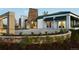 Modern home featuring a stone accent wall, well-manicured landscaping, and inviting entrance at 2078 S Teller Ct, Lakewood, CO 80227
