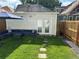 Private backyard oasis with patio furniture, putting green, and detached studio at 4418 Utica St, Denver, CO 80212