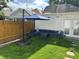 Private backyard with patio furniture and large umbrella at 4418 Utica St, Denver, CO 80212