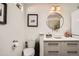 Clean bathroom with a round mirror, vessel sink, and updated vanity at 4418 Utica St, Denver, CO 80212