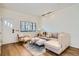 Bright living room featuring a comfortable sectional sofa and hardwood floors at 4418 Utica St, Denver, CO 80212