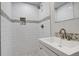 An updated bathroom features a glass-door shower and modern sink with stylish tile accents at 4835 Grove St, Denver, CO 80221