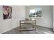 This room has a desk near a window and gray laminate flooring at 4835 Grove St, Denver, CO 80221
