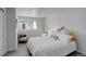 Bright bedroom featuring neutral walls and a comfortable seating area at 4835 Grove St, Denver, CO 80221