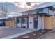 Charming two-story home featuring a fresh white exterior with black trim and a well-maintained front yard at 4835 Grove St, Denver, CO 80221