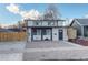 Charming home featuring a modern design with black framed windows, a well-maintained yard, and a private wooden fence at 4835 Grove St, Denver, CO 80221