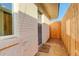 Home's front entrance featuring a brick exterior and fenced walkway at 4835 Grove St, Denver, CO 80221