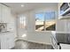 Bright kitchen offers plentiful natural light with wood floors, modern faucet, and white accents at 4835 Grove St, Denver, CO 80221
