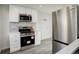 Well-equipped kitchen featuring stainless steel appliances and white cabinets at 4835 Grove St, Denver, CO 80221