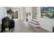 Inviting living room featuring sleek flooring, fresh paint, and stairs leading to the upper level at 4835 Grove St, Denver, CO 80221