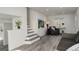 Bright living room featuring new floors and a staircase, creating a modern and comfortable space at 4835 Grove St, Denver, CO 80221