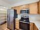 Kitchen with stainless steel appliances and wood cabinets at 8448 W Union Ave # 9, Littleton, CO 80123