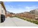Spacious backyard featuring a concrete patio, wooden fence, and garden beds at 2326 Monte Vista St, Fort Lupton, CO 80621