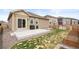 Backyard with concrete patio, wooden fence, garden beds, and a well-maintained lawn at 2326 Monte Vista St, Fort Lupton, CO 80621