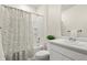 Bright bathroom featuring tub shower, toilet, vanity and large mirror at 2326 Monte Vista St, Fort Lupton, CO 80621