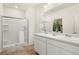 Modern bathroom with double sinks, vanity, framed mirror, and glass-enclosed shower at 2326 Monte Vista St, Fort Lupton, CO 80621