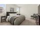 Cozy bedroom featuring neutral colors, plush carpet, and a comfortable rocking chair at 2326 Monte Vista St, Fort Lupton, CO 80621