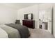 Comfortable bedroom showing a TV, dresser, and view to a living room at 2326 Monte Vista St, Fort Lupton, CO 80621
