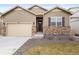 Lovely home with neutral siding, stone accents, well-maintained lawn, and attached two-car garage at 2326 Monte Vista St, Fort Lupton, CO 80621