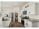 Well-equipped kitchen featuring white cabinets, stainless steel appliances, granite counters, and a walk-in pantry at 2326 Monte Vista St, Fort Lupton, CO 80621
