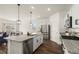 Bright kitchen features stainless steel appliances, granite countertops, and center island with stylish pendant lighting at 2326 Monte Vista St, Fort Lupton, CO 80621