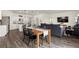 Open-concept living space showcasing a dining area, living room, and modern kitchen with stainless appliances at 2326 Monte Vista St, Fort Lupton, CO 80621