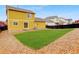 Beautiful backyard showing the home's exterior, a lush lawn, and a stone border at 25812 E Cedar Pl, Aurora, CO 80018