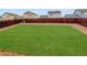 The backyard has a spacious lawn surrounded by a wooden fence and a gravel border at 25812 E Cedar Pl, Aurora, CO 80018