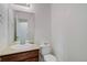 Cozy half bathroom with a floating white sink and dark wood cabinet, perfect for guests at 25812 E Cedar Pl, Aurora, CO 80018
