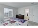Comfortable bedroom boasts a window and adjacent bathroom at 25812 E Cedar Pl, Aurora, CO 80018