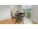 Cozy dining area features a round table, stylish chairs, and a sliding door to the backyard at 25812 E Cedar Pl, Aurora, CO 80018