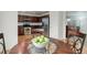 Open dining area showcasing a round table with seating and a view into the adjacent living area at 25812 E Cedar Pl, Aurora, CO 80018