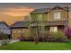 Charming two-story home with brick and siding, complemented by a well-manicured lawn and vibrant foliage at 25812 E Cedar Pl, Aurora, CO 80018