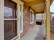 Inviting covered front porch featuring a stylish front door, stone accents, and ample natural light at 25812 E Cedar Pl, Aurora, CO 80018