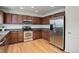 Updated kitchen with stainless steel appliances, dark cabinets, and plenty of storage space at 25812 E Cedar Pl, Aurora, CO 80018
