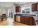 Well-lit kitchen with stainless steel appliances, dark countertops, and a view of the dining area at 25812 E Cedar Pl, Aurora, CO 80018