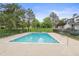 Community pool surrounded by lounge chairs, tables and mature trees, providing a relaxing atmosphere at 532 Oakwood Dr # D103, Castle Rock, CO 80104