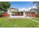 Backyard with a screened-in porch, lawn and a brick house at 1330 Quari St, Aurora, CO 80011