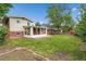 Backyard featuring a lawn, garden and screened-in porch at 1330 Quari St, Aurora, CO 80011