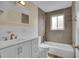 Modern bathroom with new tile, stylish fixtures, and a tub and shower combination at 1330 Quari St, Aurora, CO 80011