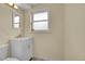 Bright bathroom featuring a white vanity, gold faucet, and a window with natural light at 1330 Quari St, Aurora, CO 80011