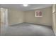 Spacious carpeted bedroom with a window and a white door, perfect for relaxation at 1330 Quari St, Aurora, CO 80011